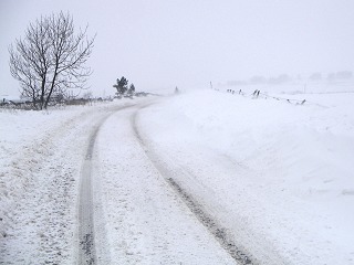 Snow drifts encroaching on road